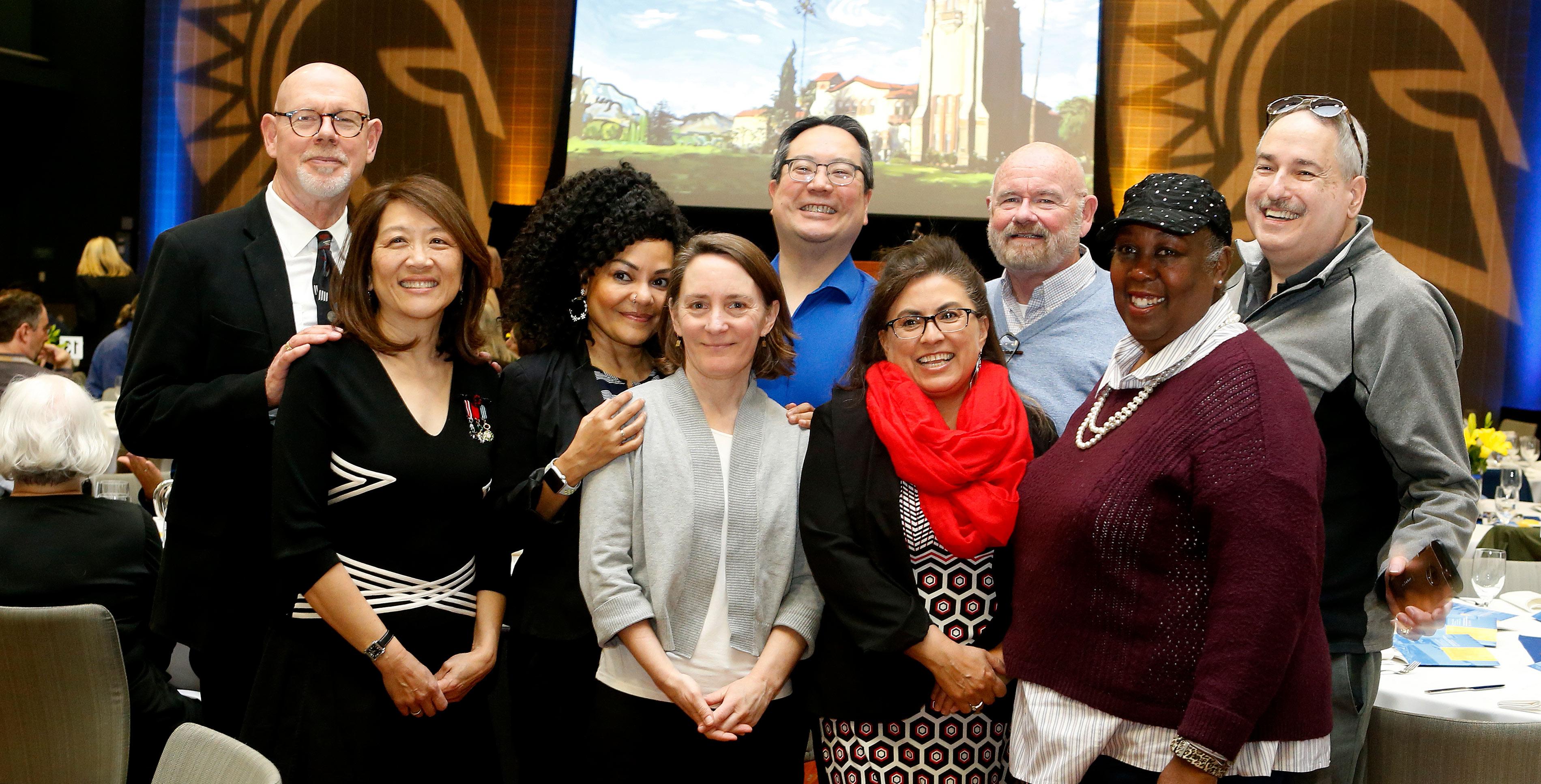 十大菠菜软件 faculty members embrace during the faculty awards ceremony.